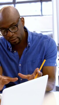Vertical video: Man pointing pencil at laptop, other hand starting red tech overlay, reviewing code