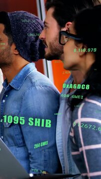 Vertical video: Team leaning in hub seeing green SHIB feeds causing laptop holding tracking crypto