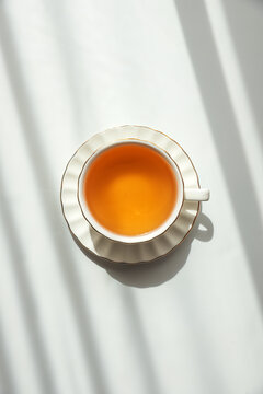 Green Tea Cup on White Table under Sunlight with Shadow