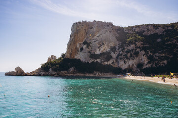 Obraz premium Cala Luna beach in Gulf of Orosei, Sardinia, Italy, with turquoise water and limestone cliffs on a sunny day
