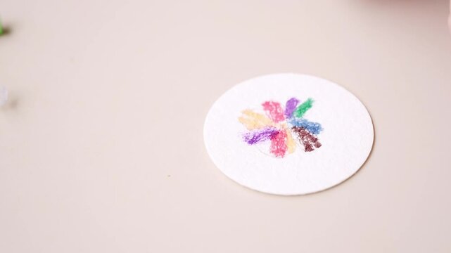 Child artist drawing flower on round paper, handmade craft card, creative drawing, cute nature picture, preschool activity, DIY hobby, creative activity holiday gift for mother or friend