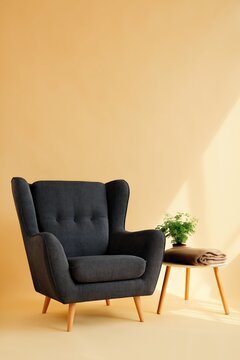 Dark upholstered armchair beside small table in studio