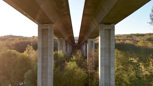Concrete highway viaduct spanning a green valley