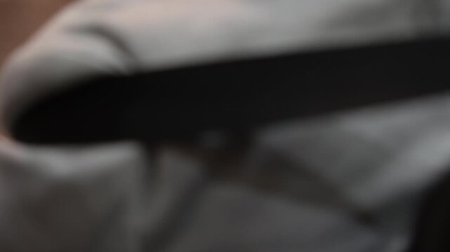Close-up of Motorized Wheelchair User Operating Joystick to Exit Lift in Modern Building
