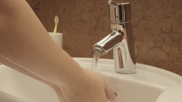 washing hands in sink, morning skincare routine in interior, Self-care and mindfulness, basic hygiene, chrome European plumbing