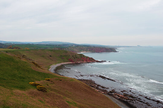 Dramatic rocky headland and coastal coves at the historic Siccar Point shoreline in Berwickshire Scotland