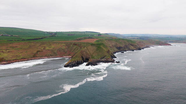 Dramatic coastal cliffs and geological formations at Siccar Point featuring Huttons Unconformity in Berwickshire Scotland
