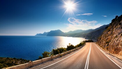 Fototapeta premium mediterranean sea coast road into mountains horizon in summer with beautiful bright sun rays