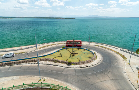 Cuba, Cienfuegos, Punta Gorda.  Double decker bus navigates around a traffic circle.