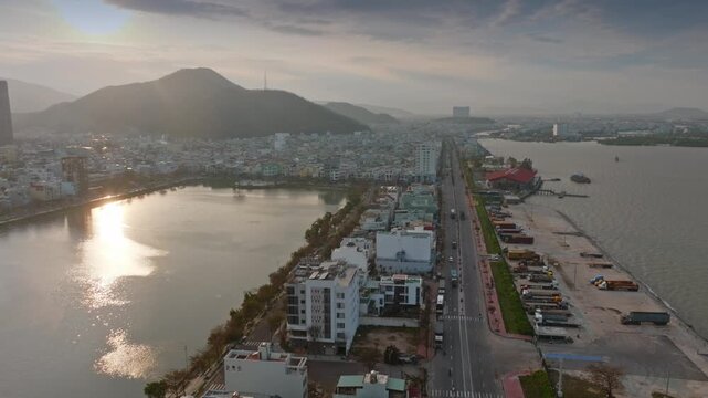Aerial view of Da Nang, Vietnam, showcasing the city's coastal development and busy port area with trucks and cargo containers along the waterfront. Ho Sinh Thai, Quy Nhon, Binh Dinh, Vietnam.