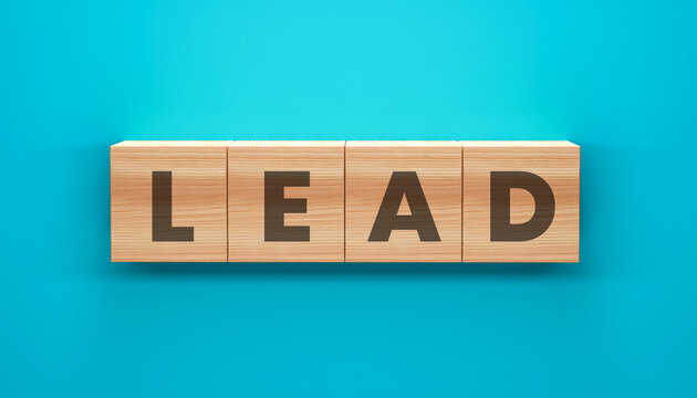 LEAD Word Cubes: A close-up shot presents wooden letter blocks arranged to spell LEAD against a serene blue backdrop. These cubes symbolize leadership, direction, and guidance.