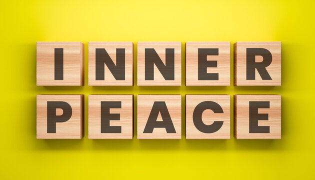 Inner Peace: A serene arrangement of wooden blocks spelling out the words INNER PEACE against a vibrant, sunny backdrop, evoking a sense of tranquility and mindfulness.