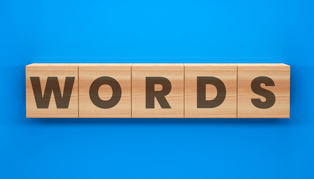 Wooden Blocks Spelling Words: The word WORDS is spelled out on wooden blocks, creating a visual representation of language, communication, and ideas on blue background.