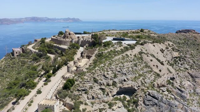 Drone view of the historic Bateria de Castillitos military coastal fortification, featuring the impressive Vickers 381mm naval guns overlooking the Mediterranean Sea in Cabo Ti&ntilde;oso, Spain. 