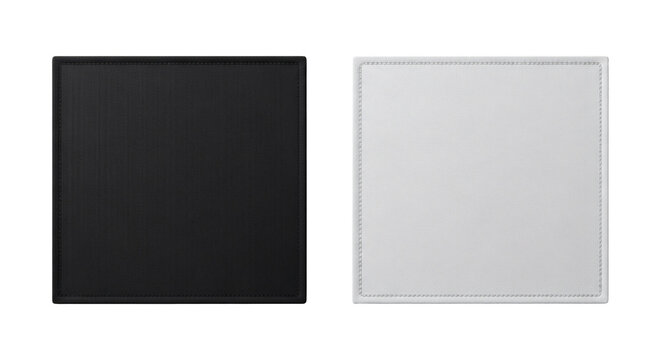 Two square leather desk mats one black and one white showing stitched edges and textured material surfaces on transparent background
