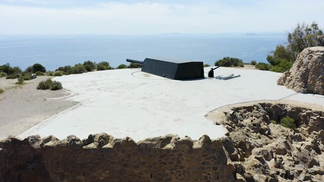 Drone view of the historic Bateria de Castillitos military coastal fortification, featuring the impressive Vickers 381mm naval guns overlooking the Mediterranean Sea in Cabo Ti&ntilde;oso, Spain. 