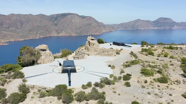 Drone view of the historic Bateria de Castillitos military coastal fortification, featuring the impressive Vickers 381mm naval guns overlooking the Mediterranean Sea in Cabo Ti&ntilde;oso, Spain. 