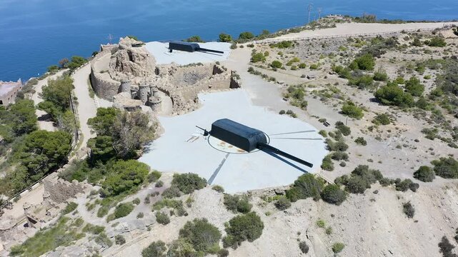 Drone view of the historic Bateria de Castillitos military coastal fortification, featuring the impressive Vickers 381mm naval guns overlooking the Mediterranean Sea in Cabo Ti&ntilde;oso, Spain. 