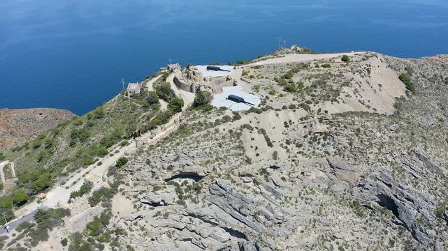 Drone view of the historic Bateria de Castillitos military coastal fortification, featuring the impressive Vickers 381mm naval guns overlooking the Mediterranean Sea in Cabo Ti&ntilde;oso, Spain. 