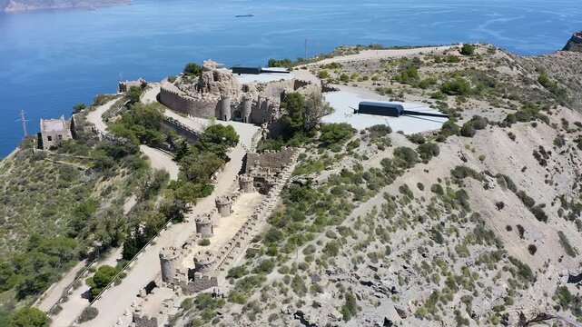 Drone view of the historic Bateria de Castillitos military coastal fortification, featuring the impressive Vickers 381mm naval guns overlooking the Mediterranean Sea in Cabo Ti&ntilde;oso, Spain. 