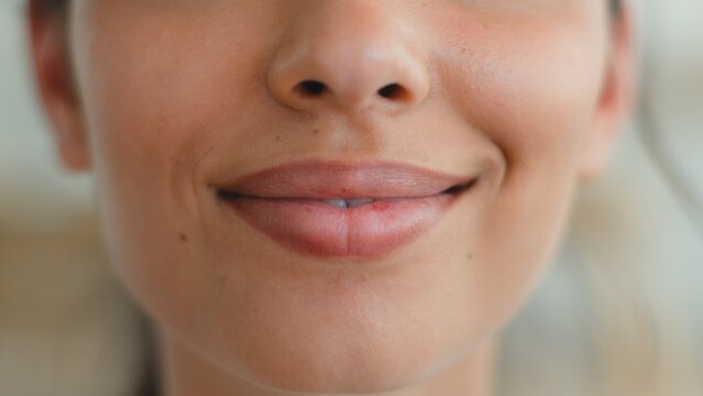 Close up lips mouth Indian Arabian woman smiling natural lipstick beauty makeup cosmetology ethnic female sensual feminine health medicine unrecognizable girl indoor lifestyle skincare aesthetic smile