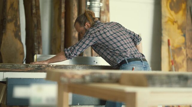 Professional carpenter using a jointer machine