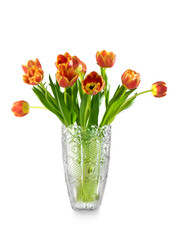 Spring tulips bunch in a crystal vase isolated on white background. Bright Tulips flower blooming. Easter, Mother's Day, birthday gift. Spring orange or red with yellow tulip flowers bouquet, cutout © Subbotina Anna