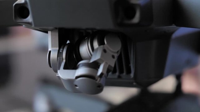 Close-up shot of a drone camera gimbal and stabilization mechanism. Cinematic macro view highlighting modern aerial technology, precision engineering, and camera movement, ideal for tech, innovation.