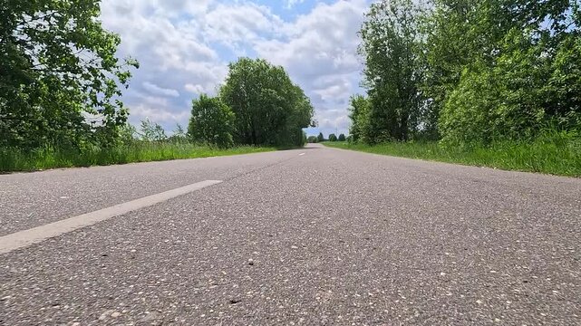 Video shooting in motion, driving a red car over the road along the asphalt at speed, view from the wheel.