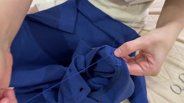 Precise sewing for garment restoration, Closeup showcase of sewing skills in clothing repair procedures, Detailed visual demonstration of hand sewing methods for restoring and repairing garments