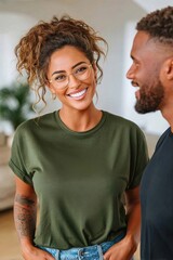 Fototapeta premium Smiling woman with glasses and curly hair talking to partner at home in casual outfit