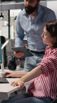Vertical Video Two colleagues waiting for AI text to video generating on computer, futuristic visuals of Mars and outer space. Artificial intelligence used to create cosmic materials of the spatial