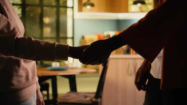 Close up, couple holding hands, reconnecting, after fight, expressing empathy, and comfort in a quiet home interior. Tenderness and affection used in resolving issues and rebuilding trust.