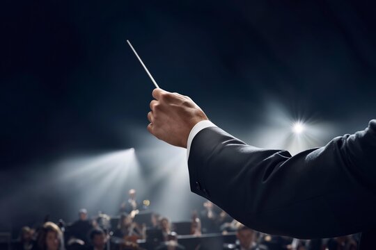 Conductor leading an orchestra with a baton