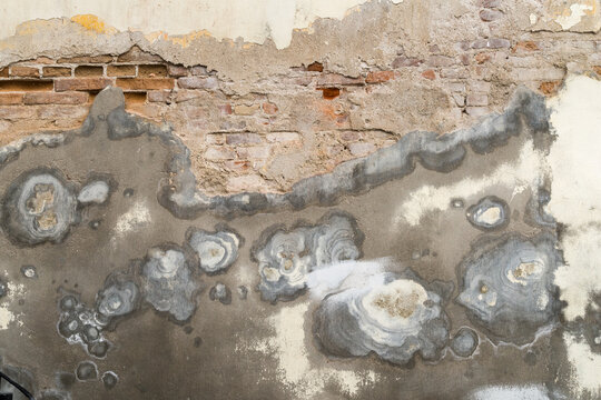Cuba, Cienfuegos.  Layers of brick, cement and stucco peeling off a wall.
