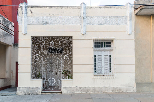Cuba, Cienfuegos.  Elaborate wrought iron screen at  entrance door to an art deco style house on the main street.