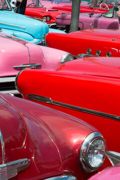 Cuba, Cienfuegos.  A collection of beautifully restored old 1950's era American automobiles.