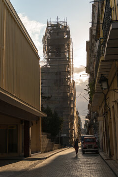 Cuba, Havana.  Alleyway in the newer part of the city, with building undergoing renovations in the background.