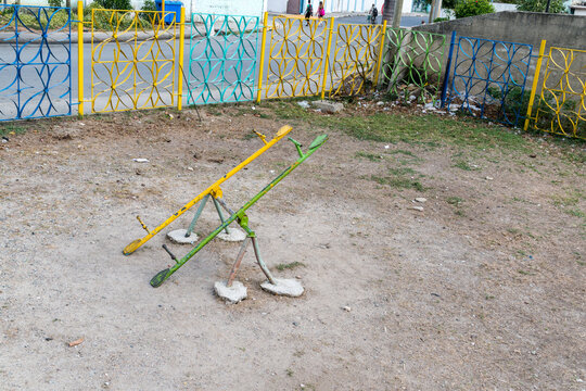 Cuba, Cienfuegos.  An uncomfortable looking seesaw ride in children's playground.