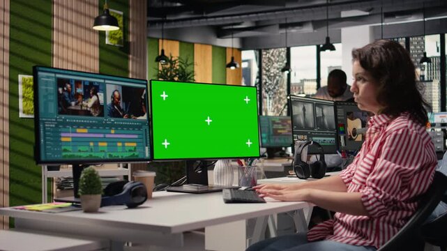 Green screen and recorded footage editing in creative office environment, filmmaker on PC workstation. Using color grading sliders for visual effects, montage tools transforming raw materials.