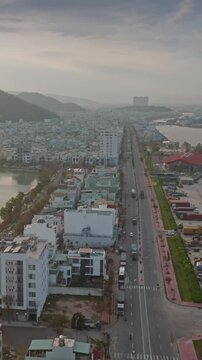 Aerial view of Da Nang, Vietnam, showcasing the city's coastal development and busy port area with trucks and cargo containers along the waterfront. Ho Sinh Thai, Quy Nhon, Binh Dinh, Vietnam.