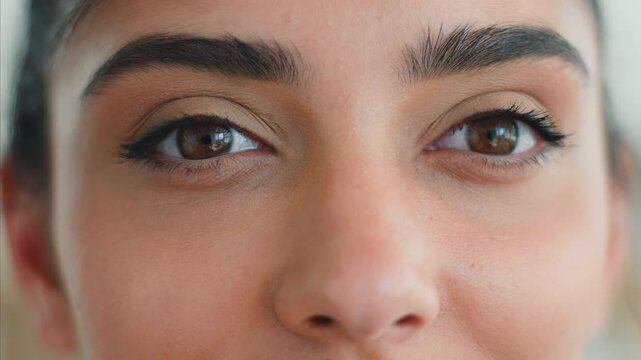 Close up Indian Muslim woman eyes looking at camera with long eyelashes beauty makeup eyeliner mascara natural look Arabian female clinic client vision eyesight health concept indoors lifestyle detail