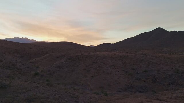 Panoramic Footage Of Drone Approaching Band Of Horses Grazing On A Desert Mesa Before Sunrise In Arizona