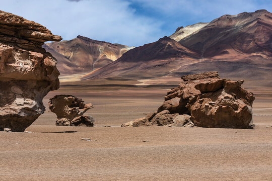 Wind-Eroded Rock Formations and Colorful Andean Mountains, Siloli Desert, Bolivian Altiplano