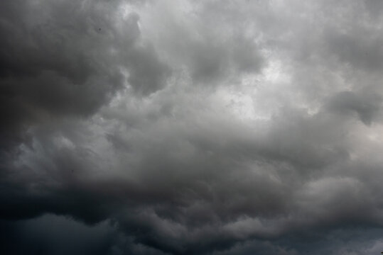 Dark gray sky cloudy environment. Meteorology danger windstorm disasters climate. Dramatic dark storm rain clouds black sky background. Dark cloudscape storm disaster gloomy gray cloud sky. Nimbus