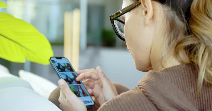 Woman Browsing Smartphone in Modern Office Lounge