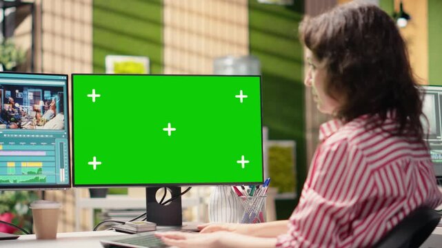 Green screen and recorded footage editing in creative office environment, filmmaker on PC workstation. Using color grading sliders for visual effects, montage tools transforming raw materials.