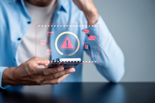 erson using smartphone with financial fraud and warning sign digital icon. Scam alert, phishing and cyber security concept.
