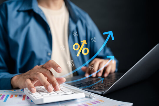 erson using calculator with percentage and upward arrow digital icon. Financial growth and interest rate concept.
