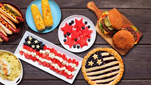 Fourth of July, patriotic, American themed food. Stop motion table placement loopable video. Top down view on a dark wood background.